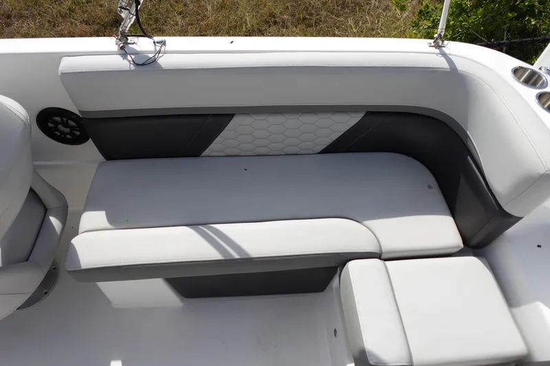 Slide: The Image of 2021 Hurricane Sundeck Sport 218 OB boat interior seating with cup holders and speaker. - 29
