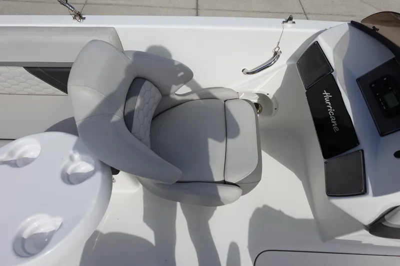 Slide: The Image of 2021 Hurricane Sundeck Sport 218 OB boat interior with seating and console. - 31