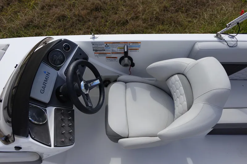 Slide: The Image of 2021 Hurricane Sundeck Sport 218 OB boat cockpit with Garmin navigation and plush seating. - 32