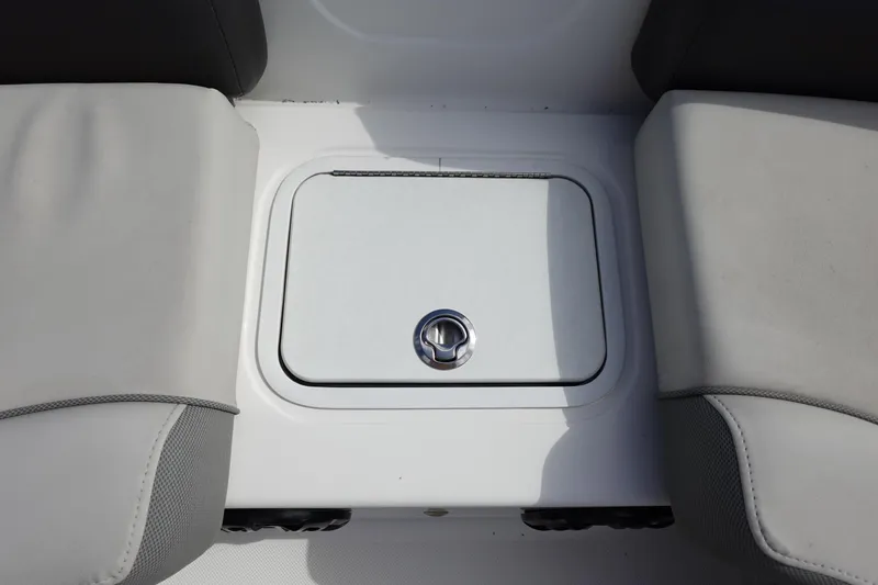 Slide: The Image of 2021 Hurricane Sundeck Sport 218 OB boat storage compartment between seats. - 44