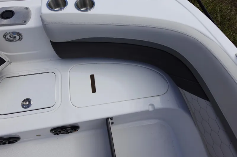 Slide: The Image of 2021 Hurricane Sundeck Sport 218 OB boat interior with cup holders and storage compartments. - 48