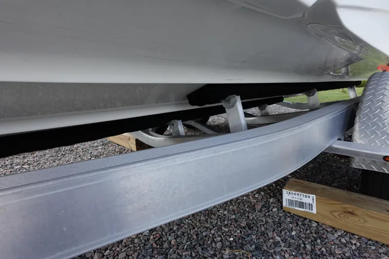 Slide: The Image of 2021 Hurricane Sundeck Sport 218 OB boat on trailer, close-up view of hull and support. - 72