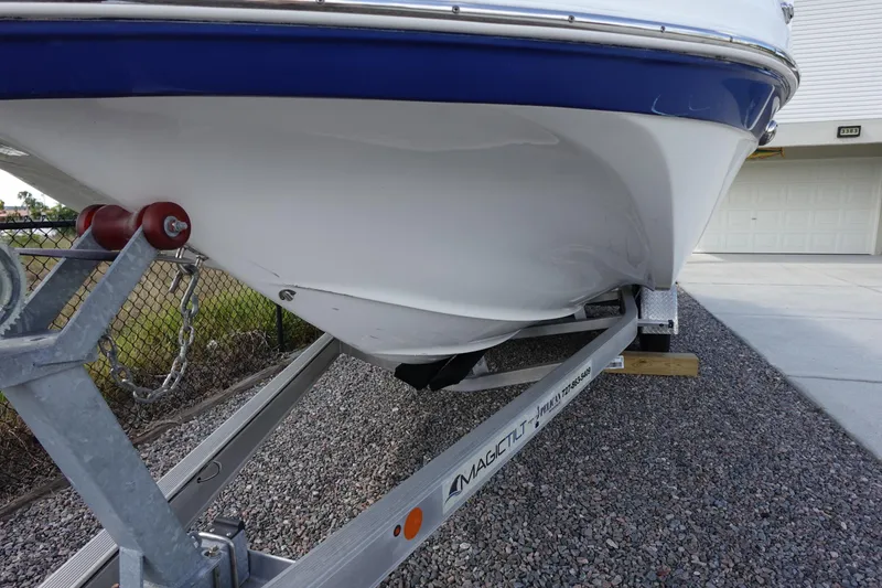 Slide: The Image of 2021 Hurricane Sundeck Sport 218 OB boat on trailer, close-up view. - 74