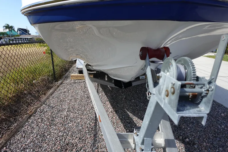 Slide: The Image of 2021 Hurricane Sundeck Sport 218 OB boat on trailer, close-up view of hull and winch. - 75
