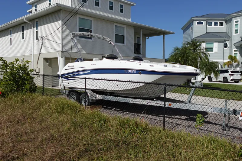 Slide: The Image of 2021 Hurricane Sundeck Sport 218 OB boat on trailer near residential homes. - 76