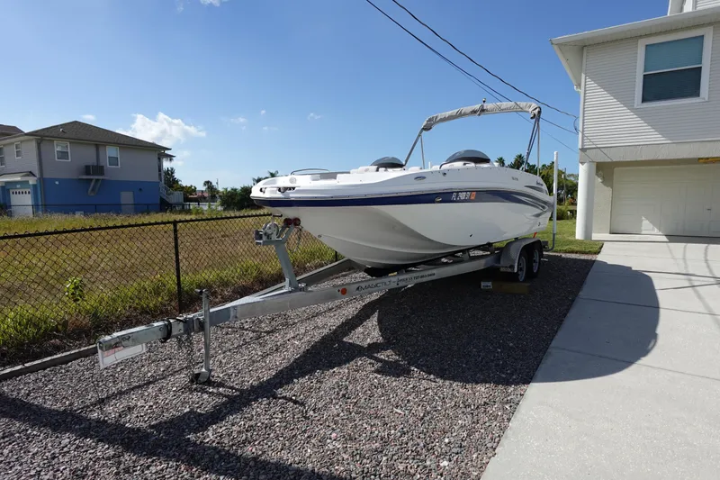 Slide: The Image of 2021 Hurricane Sundeck Sport 218 OB boat on trailer beside house. - 78