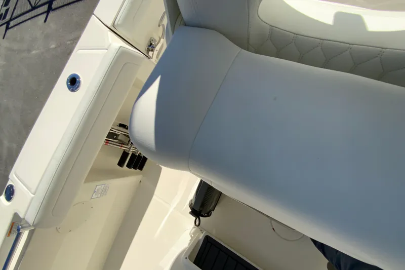 Slide: The Image of 2026 Cobia 265 Center Console boat interior with white seating and storage compartments. - 14