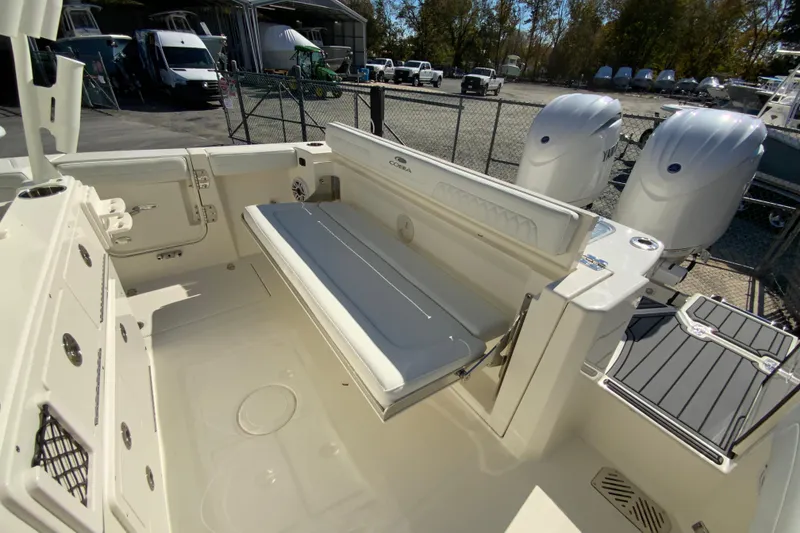 Slide: The Image of 2026 Cobia 265 Center Console boat interior with seating and dual engines. - 18