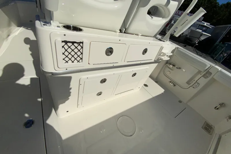 Slide: The Image of 2026 Cobia 265 Center Console boat interior with storage compartments and seating. - 19