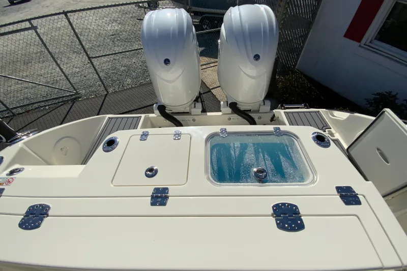 Slide: The Image of 2026 Cobia 265 Center Console boat with dual engines and livewell. - 22
