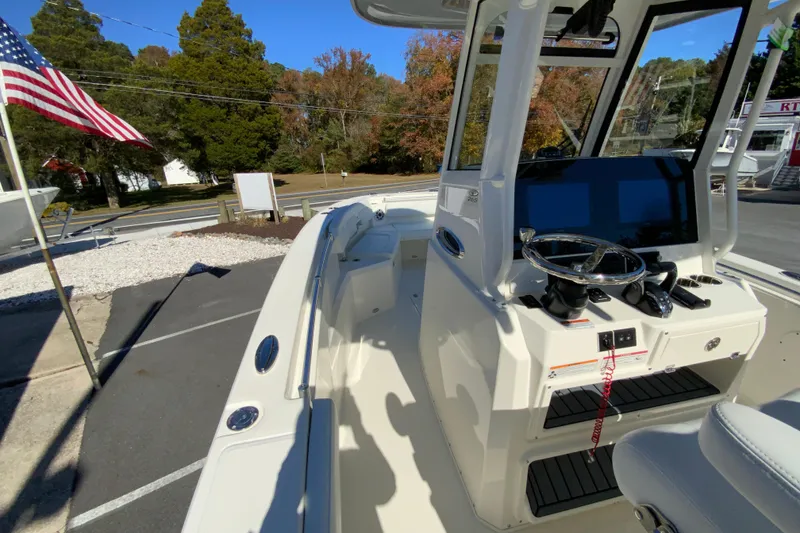 Slide: The Image of 2026 Cobia 265 Center Console boat with modern helm and American flag. - 27