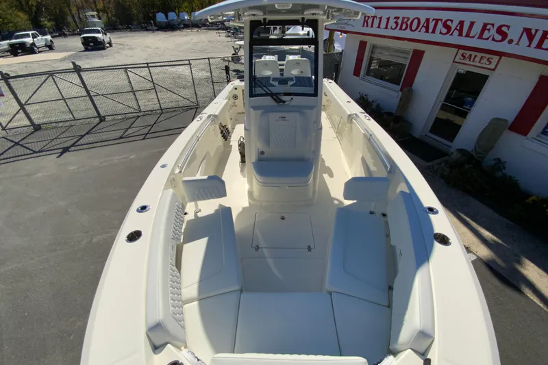 Slide: The Image of 2026 Cobia 265 Center Console boat at dealership, showcasing spacious seating and modern design. - 30