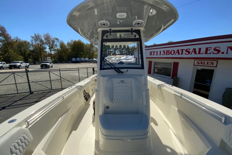 Slide: The Image of 2026 Cobia 265 Center Console boat at dealership, showcasing sleek design and spacious deck. - 33