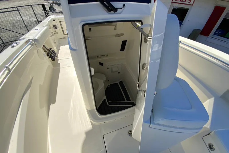 Slide: The Image of 2026 Cobia 265 Center Console boat interior with open door to cabin area. - 36