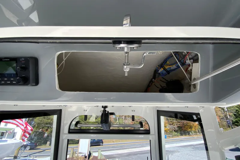 Slide: The Image of 2026 Cobia 265 Center Console interior with open hatch and visible wiring. - 40