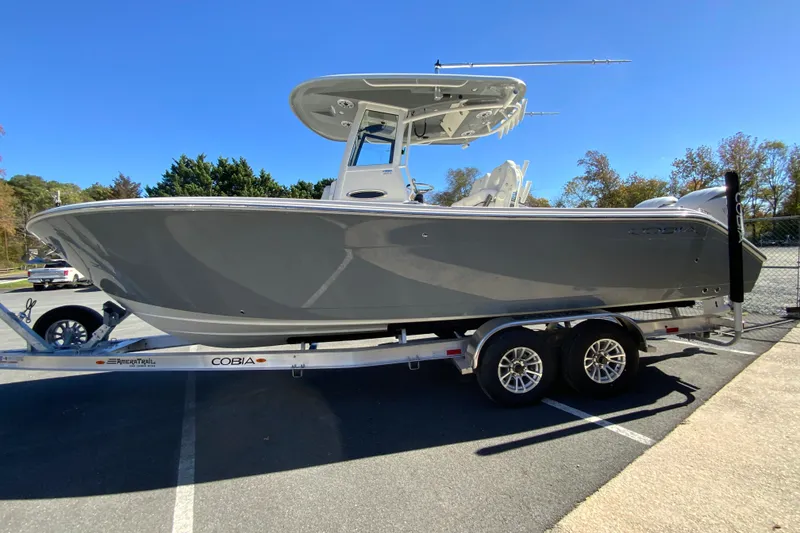 Slide: The Image of 2026 Cobia 265 Center Console boat on trailer in parking lot. - 6