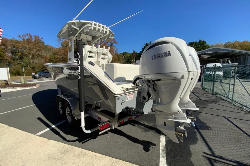 Slide: The Image of 2026 Cobia 265 Center Console boat with dual Yamaha engines on a trailer. - 7