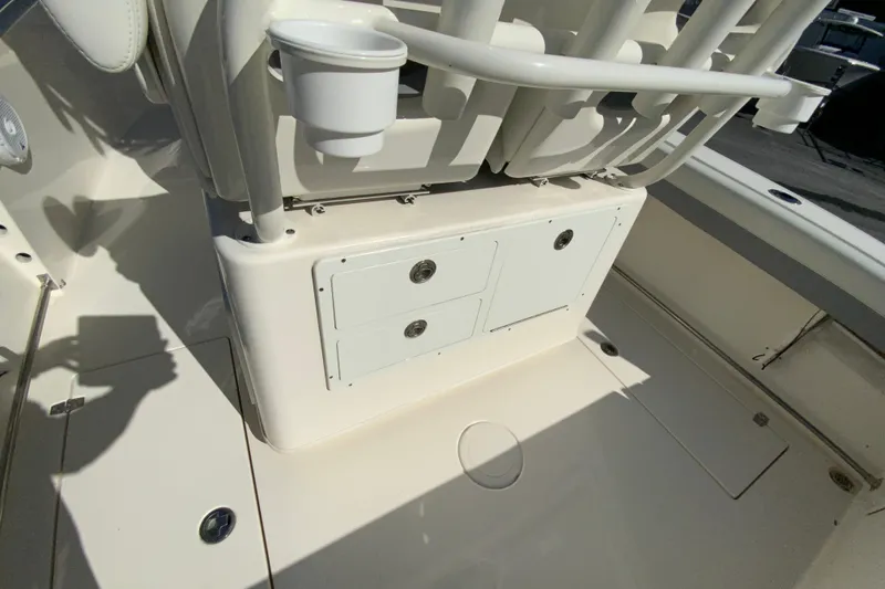 Slide: The Image of 2019 Cobia 262 Center Console boat interior with storage compartments and cup holder. - 17