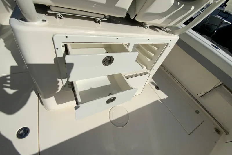 Slide: The Image of 2019 Cobia 262 Center Console boat with open storage drawers. - 18