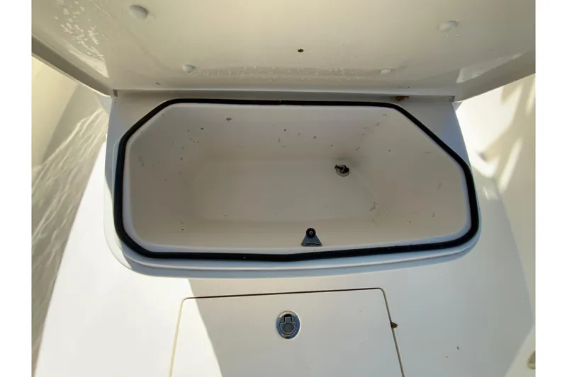 Slide: The Image of Open storage compartment on a 2019 Cobia 262 Center Console boat. - 28