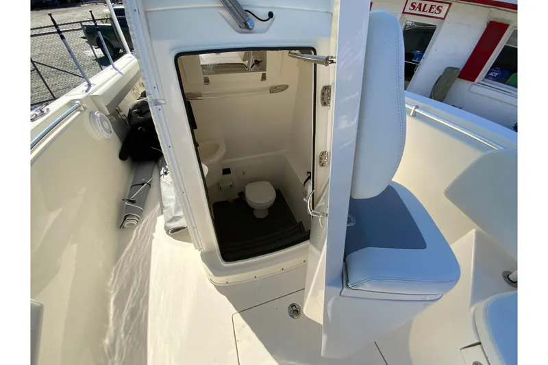 Slide: The Image of 2019 Cobia 262 Center Console boat with open bathroom compartment. - 29