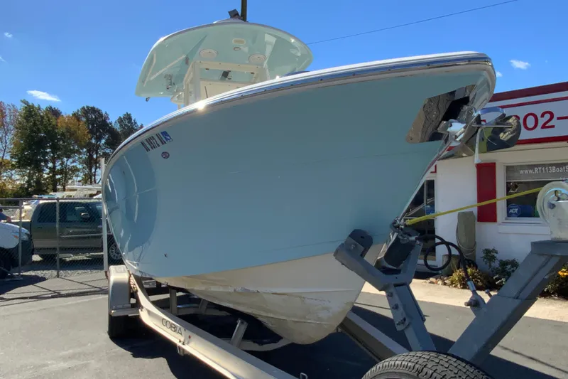 Slide: The Image of 2019 Cobia 262 Center Console boat on trailer, parked outdoors. - 3