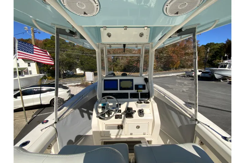 Slide: The Image of 2019 Cobia 262 Center Console boat interior with navigation equipment and American flag. - 32