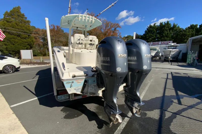 Slide: The Image of 2019 Cobia 262 Center Console boat with dual Yamaha 150 engines in a sales lot. - 8