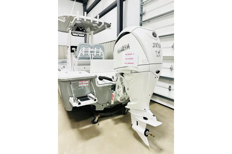 Slide: The Image of 2026 Sportsman Masters 247OE Bay Boat with Yamaha engine in a garage setting. - 16