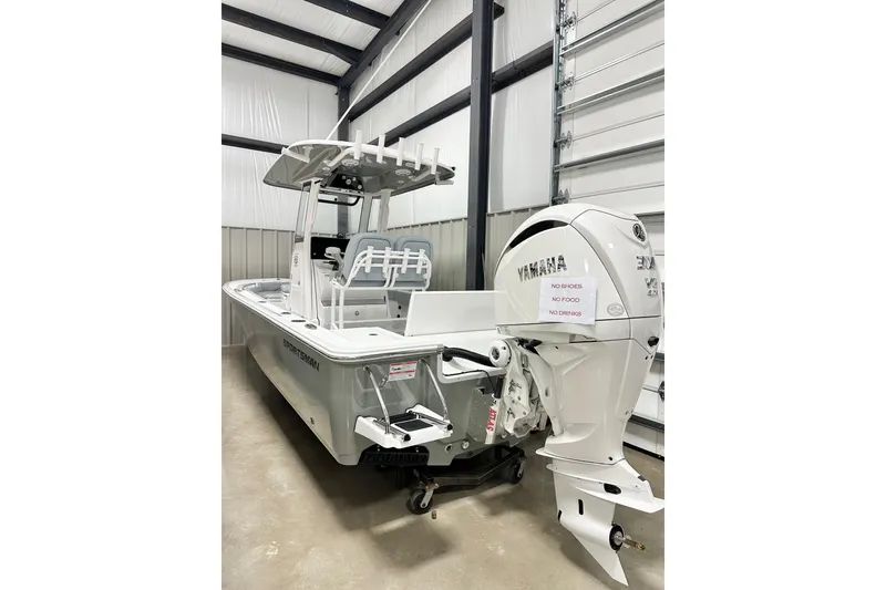 The Image of 2026 Sportsman Masters 247OE Bay Boat with Yamaha engine in storage facility. - 2