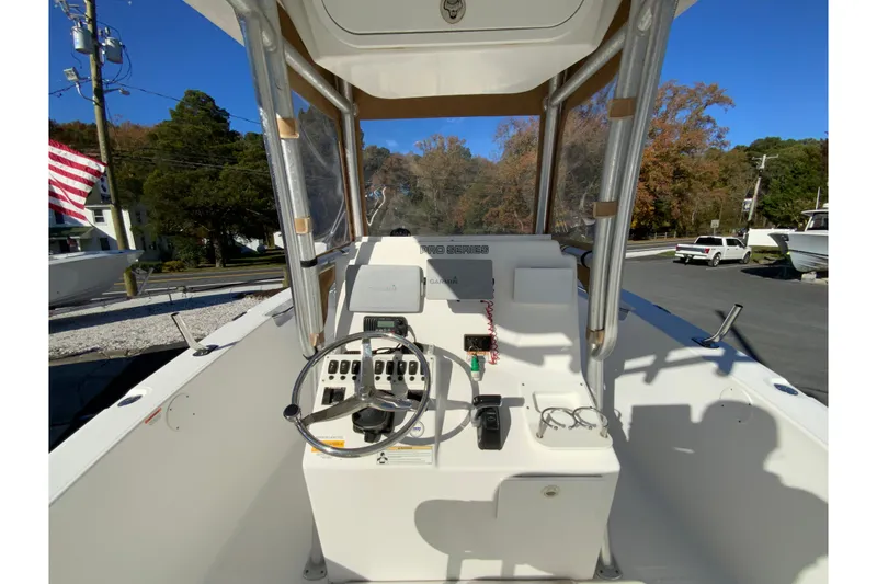 Slide: The Image of 2011 Sea Fox 256 Center Console boat interior with steering wheel and control panel. - 11
