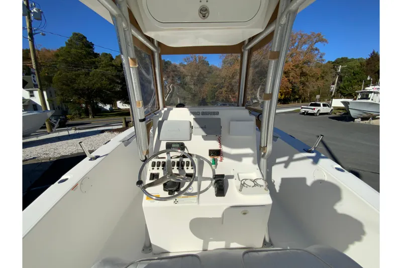 Slide: The Image of 2011 Sea Fox 256 Center Console boat interior with steering wheel and controls. - 12