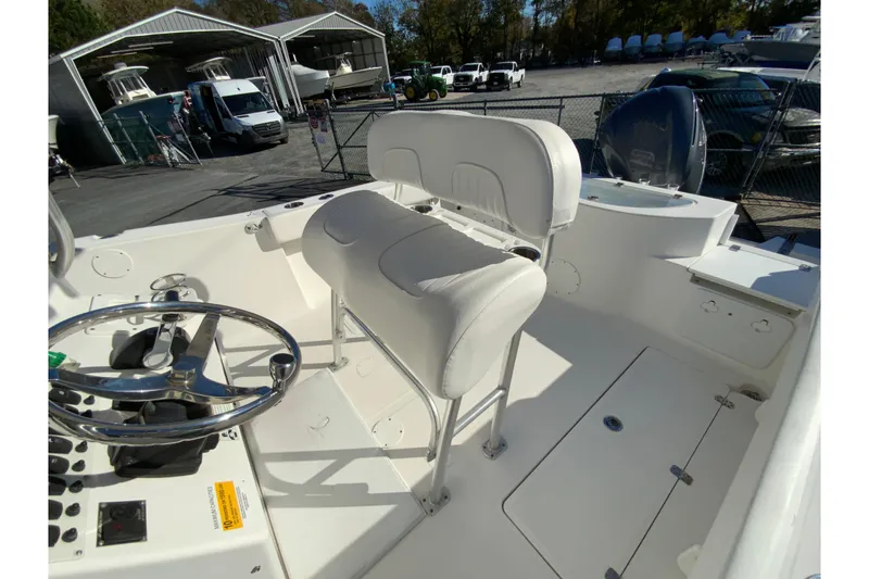 Slide: The Image of 2011 Sea Fox 256 Center Console boat interior with steering wheel and seating. - 14