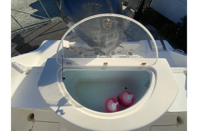 Slide: The Image of 2011 Sea Fox 256 Center Console livewell with pink containers inside. - 16