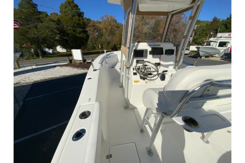 Slide: The Image of 2011 Sea Fox 256 Center Console boat with helm and seating, docked outdoors. - 17