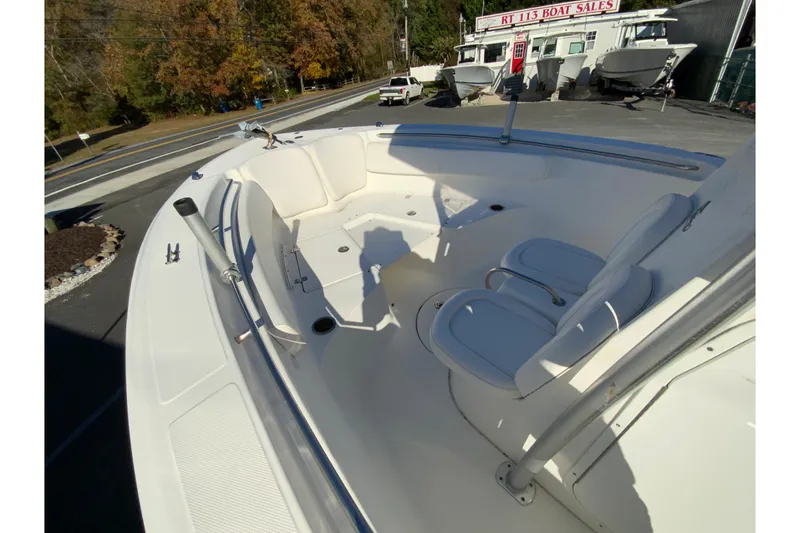 Slide: The Image of 2011 Sea Fox 256 Center Console boat interior with seating, displayed at a boat sales lot. - 19