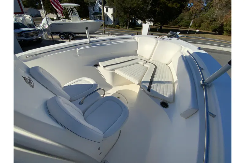 Slide: The Image of 2011 Sea Fox 256 Center Console boat interior with cushioned seating and steering area. - 22