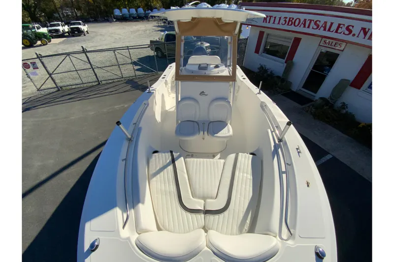 Slide: The Image of 2011 Sea Fox 256 Center Console boat at dealership, showcasing spacious seating and sleek design. - 23