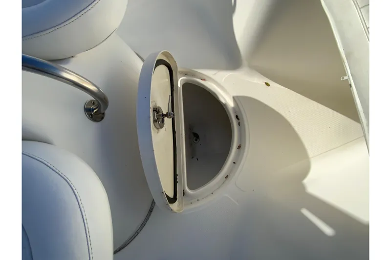 Slide: The Image of Open storage compartment on a 2011 Sea Fox 256 Center Console boat. - 24