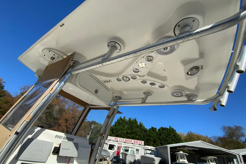 Slide: The Image of 2011 Sea Fox 256 Center Console boat with T-top and electronics, under clear blue sky. - 29