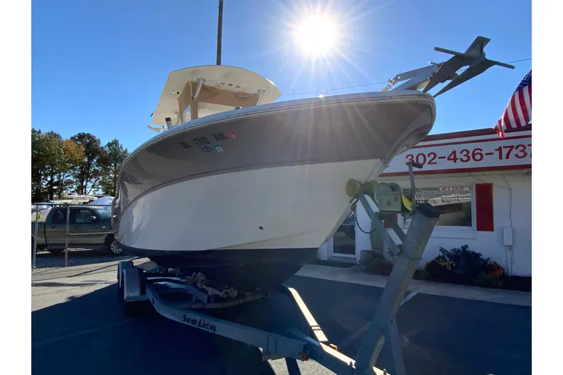 Slide: The Image of 2011 Sea Fox 256 Center Console boat on trailer under bright sun. - 3