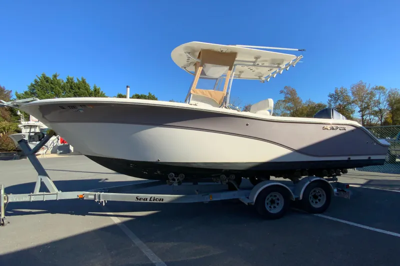 Slide: The Image of 2011 Sea Fox 256 Center Console boat on trailer, parked outdoors. - 6