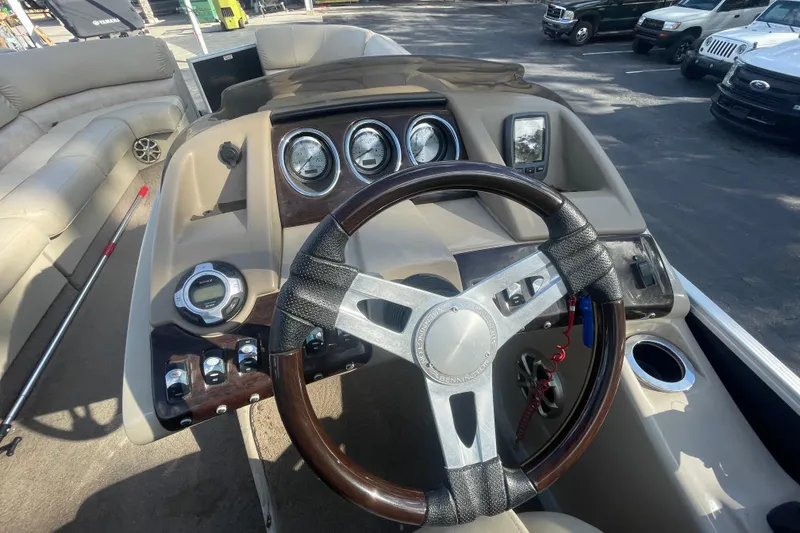 Slide: The Image of 2013 Bennington R22 boat dashboard with steering wheel and gauges. - 12