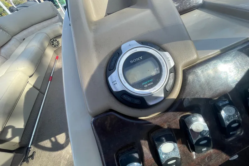 Slide: The Image of 2013 Bennington R22 boat dashboard with Sony marine audio system and control switches. - 13