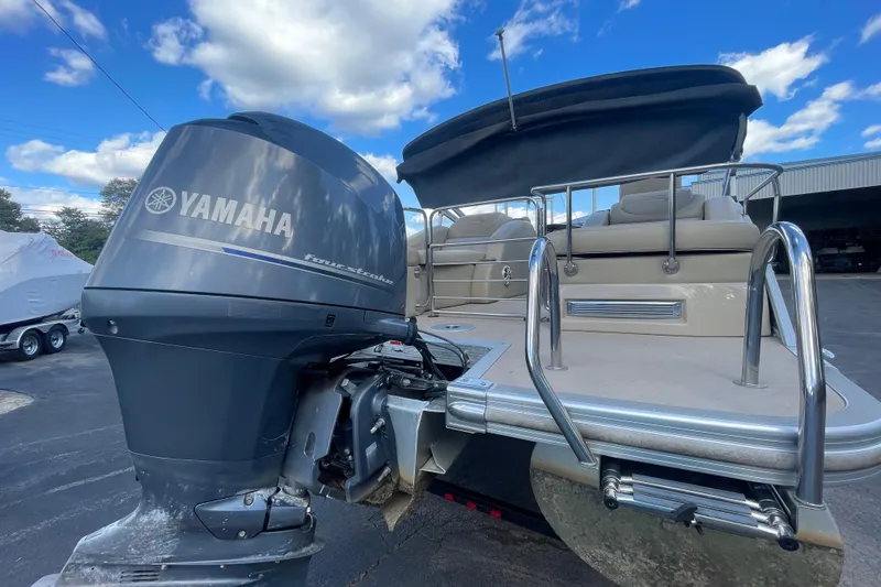 Slide: The Image of 2013 Bennington R22 boat with Yamaha four-stroke engine, docked under blue sky. - 18