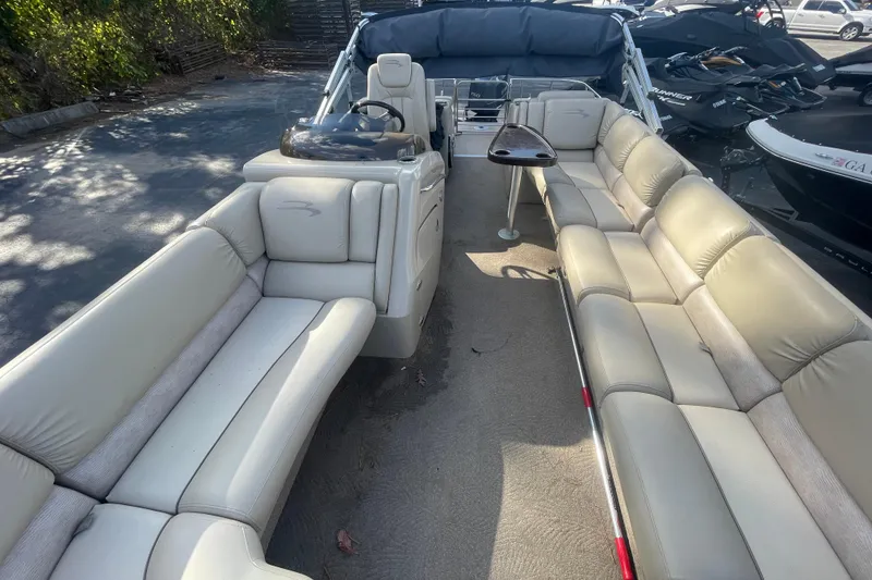 Slide: The Image of 2013 Bennington R22 pontoon boat interior with beige seating and steering console. - 4