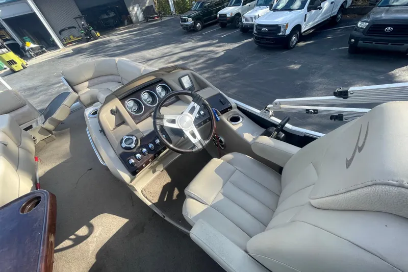 Slide: The Image of 2013 Bennington R22 boat interior with steering wheel and dashboard controls. - 8