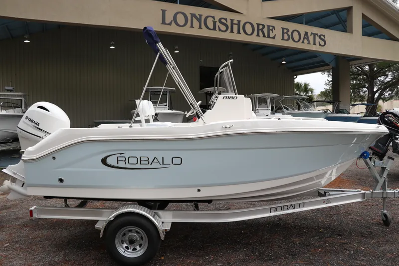 The Image of 2026 Robalo R180 Center Console boat on trailer at Longshore Boats dealership. - 0