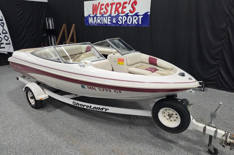 Slide: The Image of 1996 Glastron SX175 boat interior with worn upholstery and steering wheel. - 2