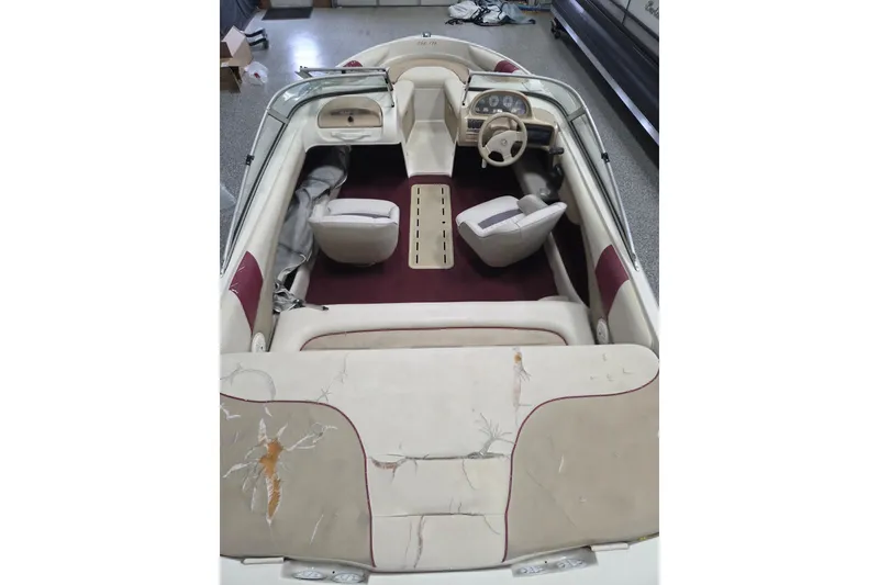 Slide: The Image of 1996 Glastron SX175 boat interior with red and beige seating. - 3